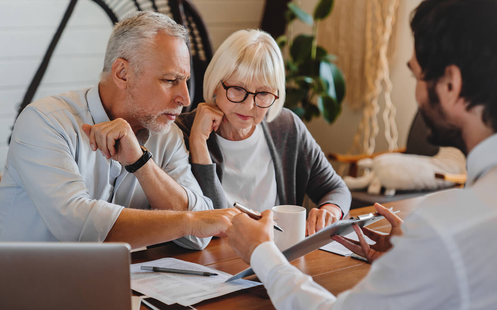An older couple sits at a table, discussing matters related to litigation.